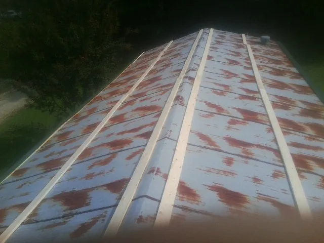 Rusted metal roof panels with new wood purlins before replacement — Storm Damage Roof Repair in Hockingport by Roofing Brothers