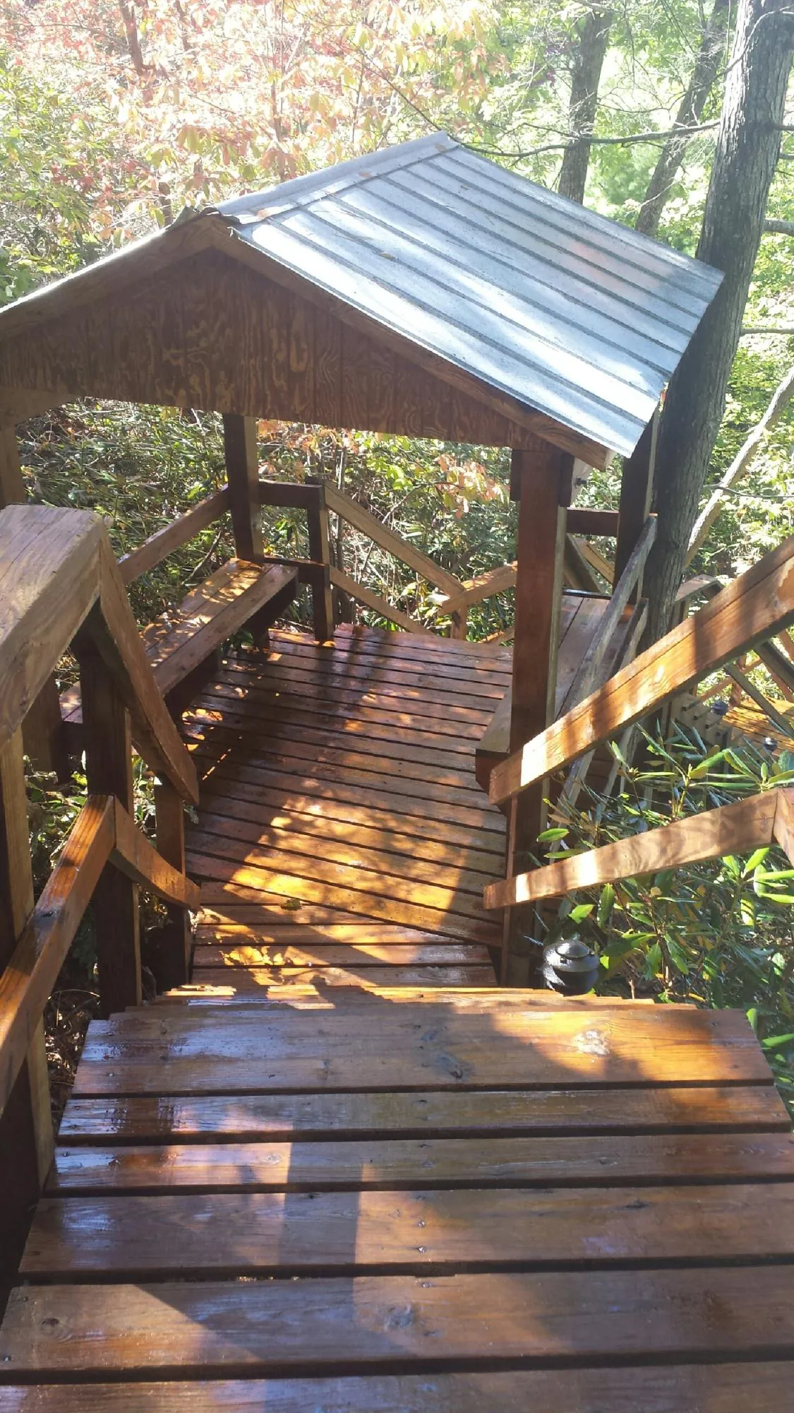 Freshly stained wood walkway and covered shelter with a metal roof in Hockingport