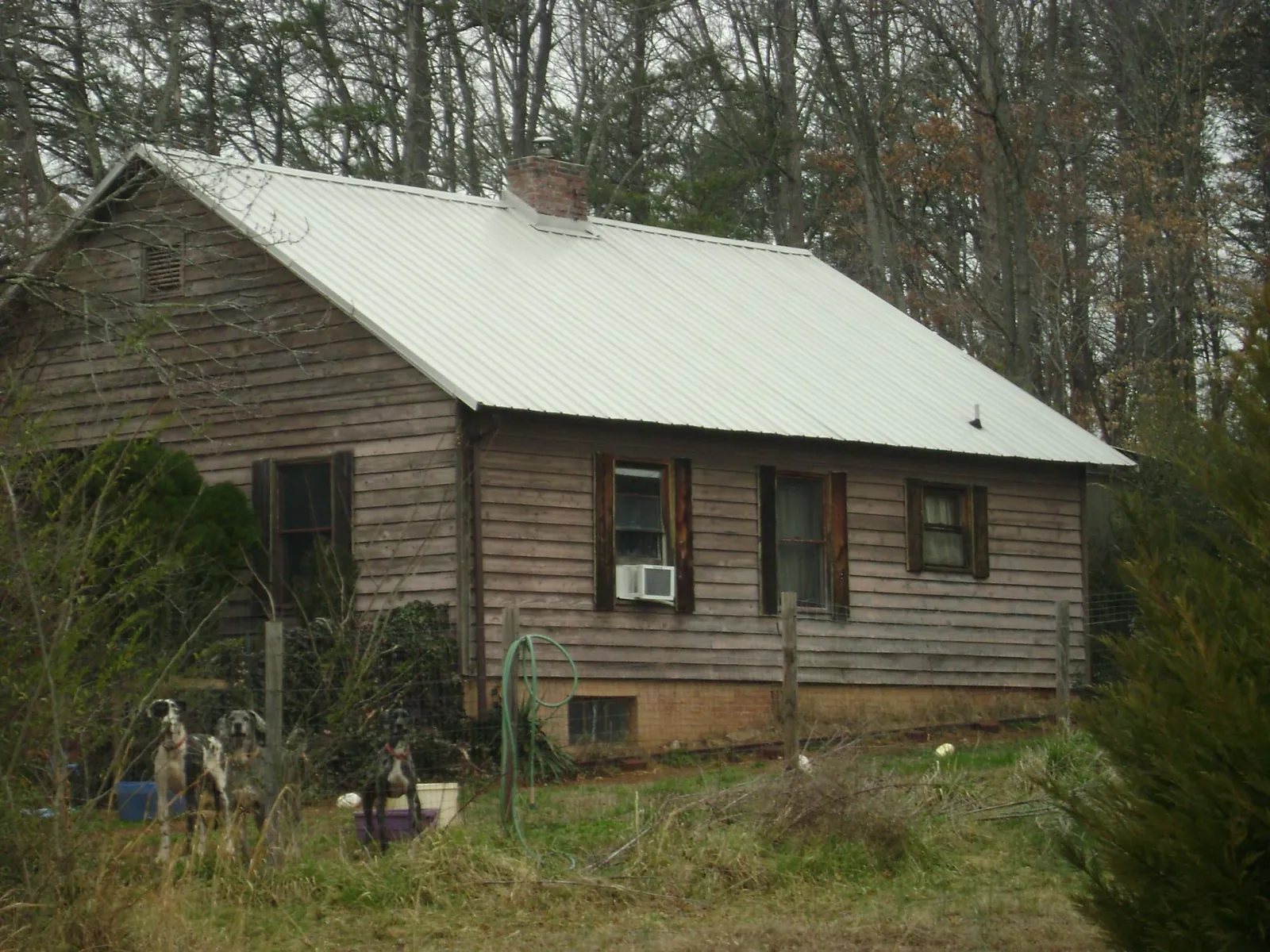 White metal roof on an old wood sided farmhouse, from a Metal Roof Installation job in Hockingport